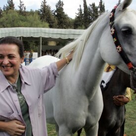 Princess Alia Bint Al Hussein strokes her horse Monarcoss DD an Arabian filly, during the Middle East Championships horse show at the Royal stables in Amman, October 18, 2008. Dozens of Arabian horses from the Middle East are taking part in the three-day show.  AFP PHOTO/KHALIL MAZRAAWI